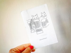 postcard of a stencil of cats on houses in iceland
