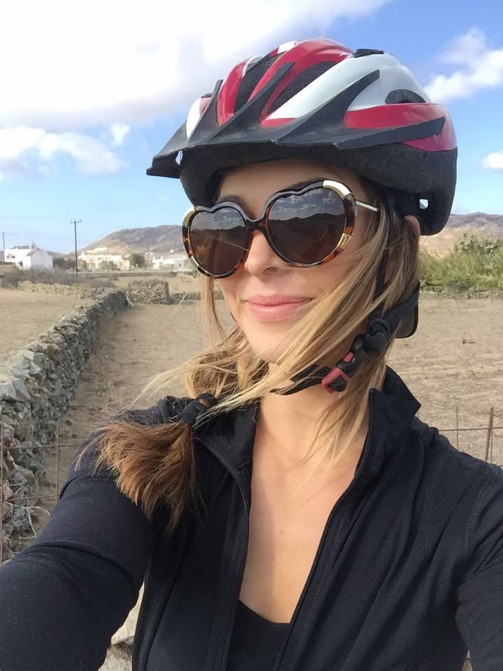 smiling woman wearing bike helmet in Greece