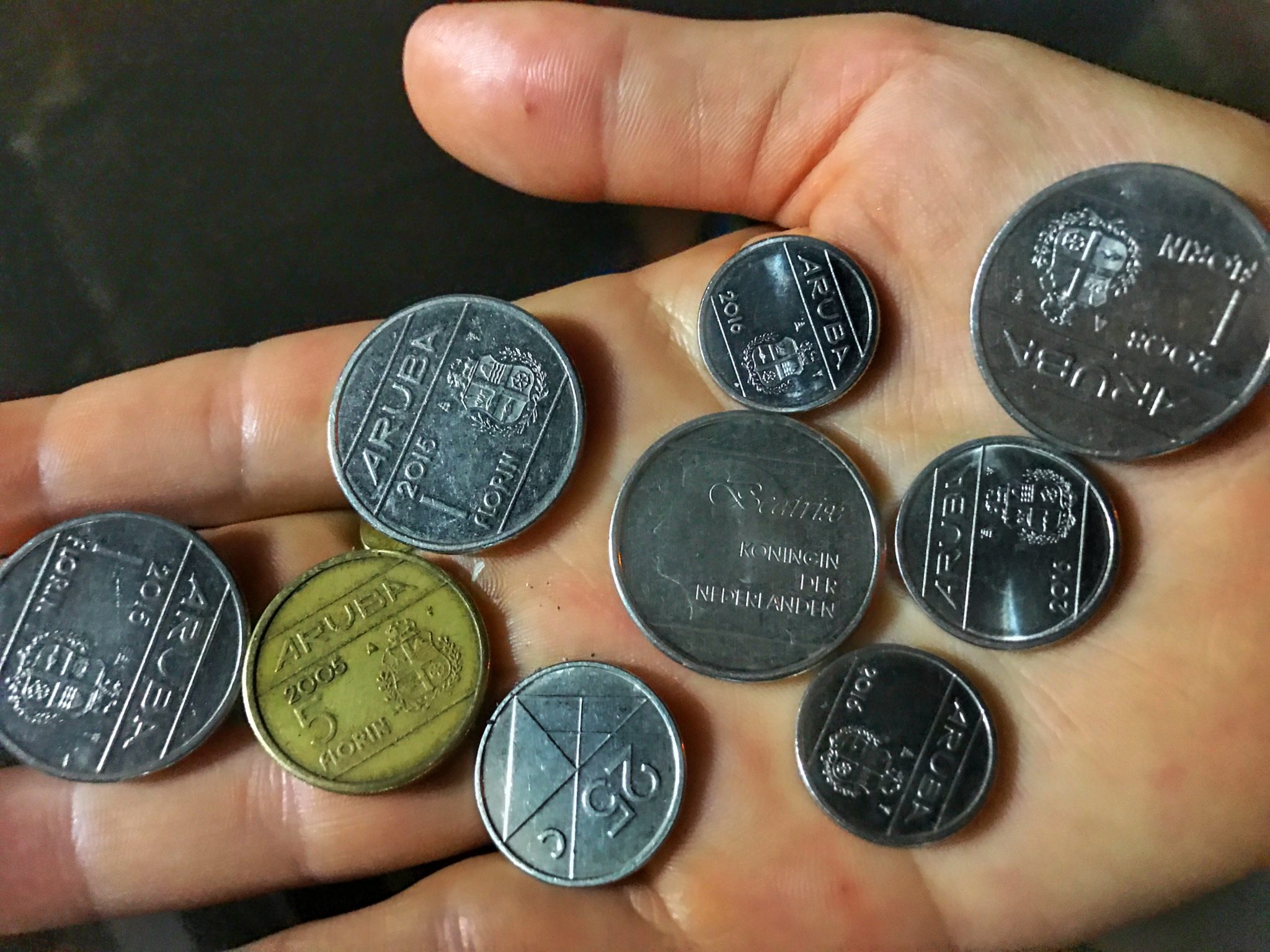 arubian coins in a hand