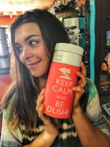 woman holding a thermos that says Keep Calm and Be Dushi