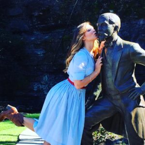 woman kissing a statue of Jack Daniels