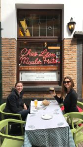 Two Women Smiling Outside of Chez Leon Restaurant in Brussels