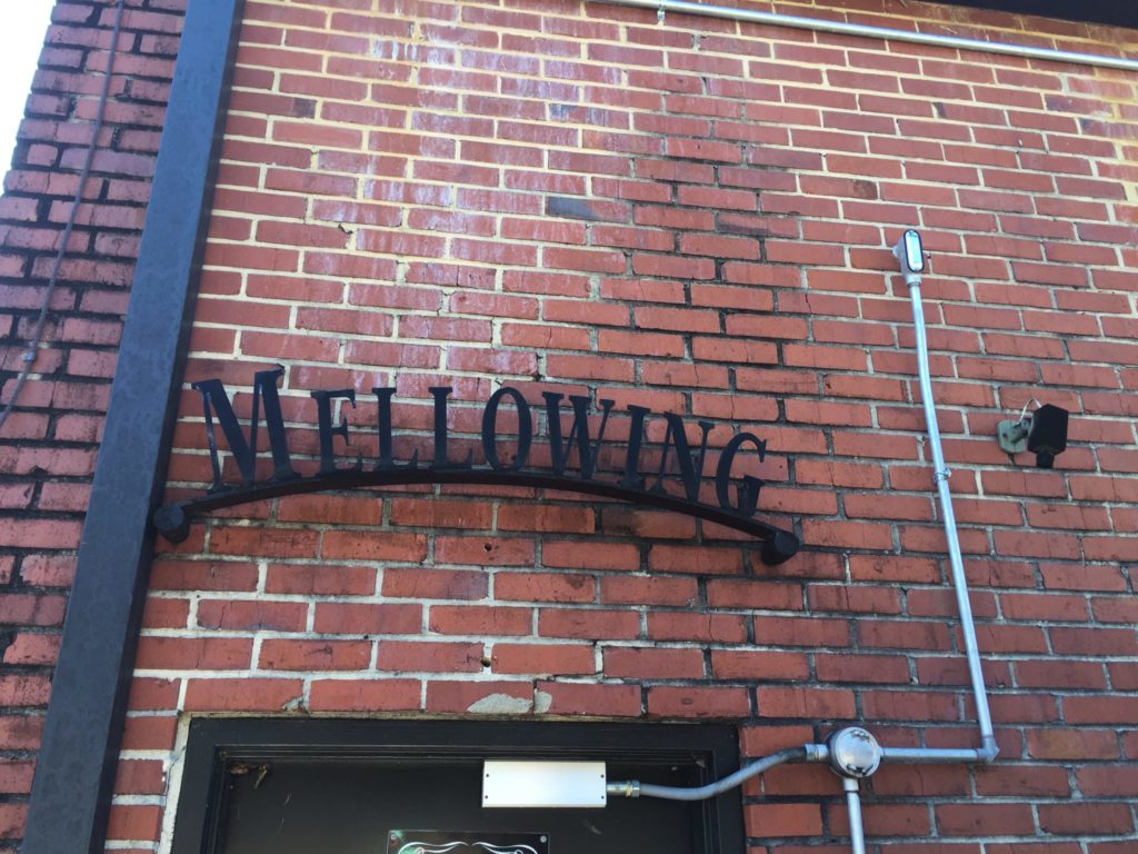 Outside of Jack Daniels distillery with sign that say Mellowing
