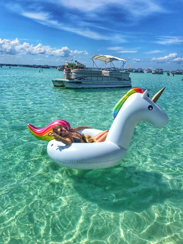 woman smiling on unicorn floaty