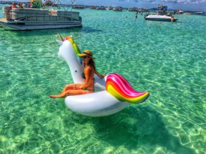 woman floating on an inflatable unicorn