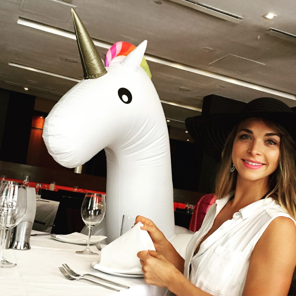 Inflatable Unicorn and Woman At Table in Miami Beach