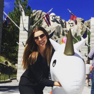 woman and inflatable unicorn at Mount Rushmore
